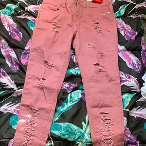 Pink distressed denim jeans